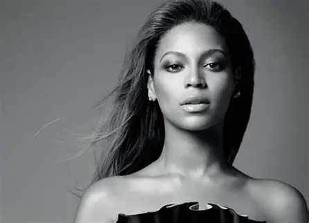 Beyonce posed in front of a grey background